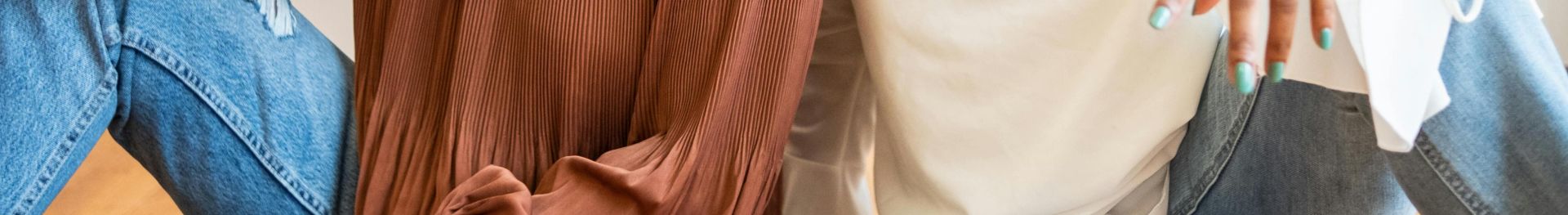 Two African American women laughing and enjoying each other's company indoors.